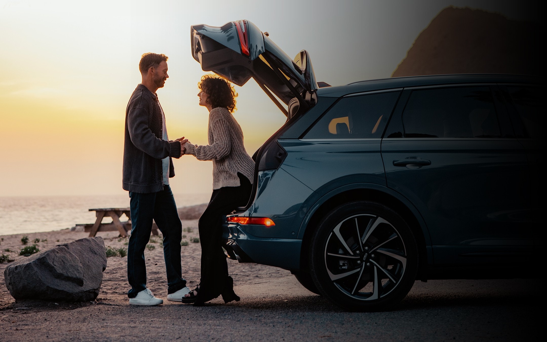 A person with hands full is engaged with the hands-free power liftgate